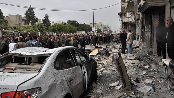 Syrian residents and security forces inspect the damage following a car bomb explosion on April 10, 2015, in the government-controlled majority Alawite neighbourhood of Hay al-Arman, located on the outskirts of the Zahraa district in Homs city Syrian residents and security forces inspect the damage following a car bomb explosion on April 10, 2015, in the government-controlled majority Alawite neighbourhood of Hay al-Arman, located on the outskirts of the Zahraa district in Homs city - Sputnik International