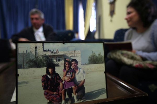 Ghassan Jarrar (background), the husband of Khalida Jarrar (portrait-L), a member of the Popular Front for the Liberation of Palestine (PFLP), sits behind a family picture on April 2, 2015 at their home in the West Bank city of Ramallah, where she was arrested the day before Ghassan Jarrar (background), the husband of Khalida Jarrar (portrait-L), a member of the Popular Front for the Liberation of Palestine (PFLP), sits behind a family picture on April 2, 2015 at their home in the West Bank city of Ramallah, where she was arrested the day before - Sputnik International