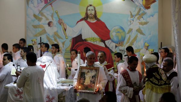 Egyptian Coptic Christians pray during the Easter Eve service at St. Sama'ans Church in the Mokattam district of Cairo, Egypt Egyptian Coptic Christians pray during the Easter Eve service at St. Sama'ans Church in the Mokattam district of Cairo, Egypt - Sputnik International