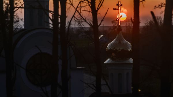 The Sun sets behind the St. Yelisei’s Lavrishevo monetary during Orthodox Easter at the village of Gnesichi in the Grodno region, about 150 km from Minsk The Sun sets behind the St. Yelisei’s Lavrishevo monetary during Orthodox Easter at the village of Gnesichi in the Grodno region, about 150 km from Minsk - Sputnik International