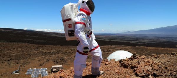 In this June 4 2013 photo provided by the University of Hawaii, research space scientist Oleg Abramov walks outside simulated Martian base at Mauna Loa, Hawaii - Sputnik International