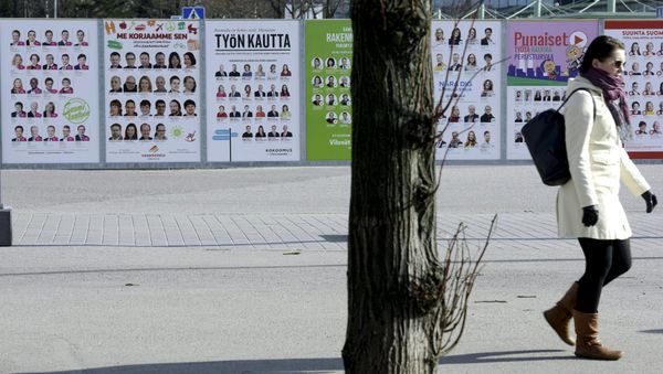 A woman walks past campaign posters of candidates in the Finnish Parliamentary elections put up along a street in Helsinki, April 10, 2015 A woman walks past campaign posters of candidates in the Finnish Parliamentary elections put up along a street in Helsinki, April 10, 2015 - Sputnik International