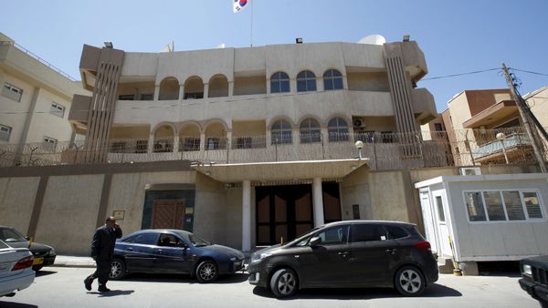 A man walks past the South Korean embassy after it was attacked by gunmen in Tripoli April 12, 2015. A man walks past the South Korean embassy after it was attacked by gunmen in Tripoli April 12, 2015. - Sputnik International