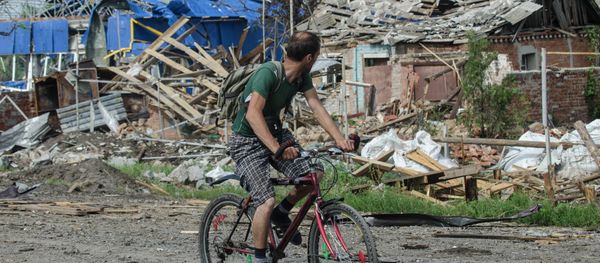 A local citizen rides a bicycle past destroyed houses after heavy fighting between independence supporters and Ukrainian government troops just outside Slovyansk, eastern Ukraine, Wednesday, July 9, 2014 A local citizen rides a bicycle past destroyed houses after heavy fighting between independence supporters and Ukrainian government troops just outside Slovyansk, eastern Ukraine, Wednesday, July 9, 2014 - Sputnik International
