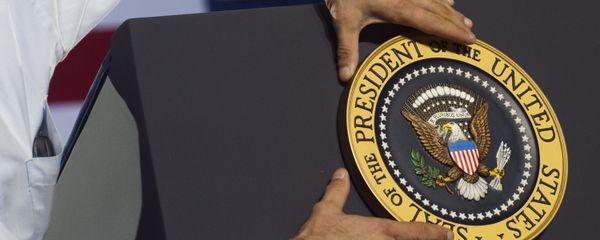An aide places the Presidential seal on the podium prior to US President Barack Obama speaking during a campaign event at Kissimmee Civic Center in Kissimmee, Florida An aide places the Presidential seal on the podium prior to US President Barack Obama speaking during a campaign event at Kissimmee Civic Center in Kissimmee, Florida - Sputnik International