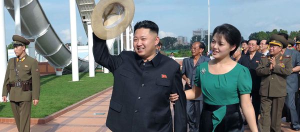 North Korean leader Kim Jong Un, center, accompanied by his wife Ri Sol Ju, right, waves to the crowd as they inspect the Rungna People's Pleasure Ground in Pyongyang North Korean leader Kim Jong Un, center, accompanied by his wife Ri Sol Ju, right, waves to the crowd as they inspect the Rungna People's Pleasure Ground in Pyongyang - Sputnik International