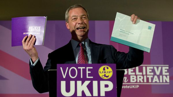 Nigel Farage leader of the UK Independence Party holds up his party's election manifesto, left, and economic policy review, right, during its launch at a media event in Thurrock, England, Wednesday, April 15, 2015 Nigel Farage leader of the UK Independence Party holds up his party's election manifesto, left, and economic policy review, right, during its launch at a media event in Thurrock, England, Wednesday, April 15, 2015 - Sputnik International
