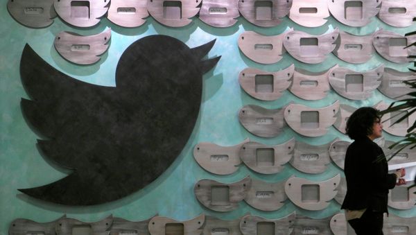 A woman walks past artwork at tech company Twitter's office space in Santa Monica, California - Sputnik International