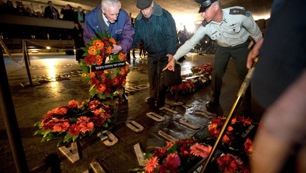 Holocaust survivors and their relatives lay a wreath next to the names of concentration camps during a ceremony marking the annual Holocaust Remembrance Day at the Hall of Remembrance at the Yad Vashem Holocaust memorial, in Jerusalem - Sputnik International