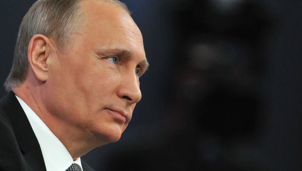 Russian President Vladimir Putin listens to a question during his annual televised phone-in with the nation in central Moscow on April 16, 2015. - Sputnik International