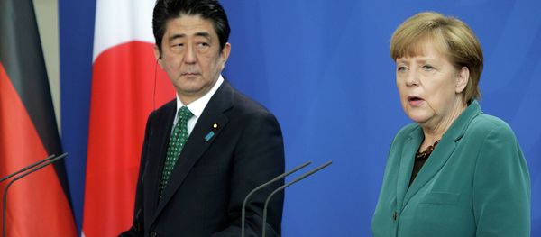 German Chancellor Angela Merkel and Prime Minister of Japan Shinzo Abe address the media during a joint press conference as part of a meeting at the chancellery in Berlin. German Chancellor Angela Merkel and Prime Minister of Japan Shinzo Abe address the media during a joint press conference as part of a meeting at the chancellery in Berlin. - Sputnik International
