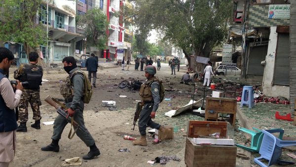 Afghan security forces members inspect the site of a suicide attack near a new Kabul Bank in Jalalabad, east of Kabul, Afghanistan, Saturday, April, 18, 2015. - Sputnik International