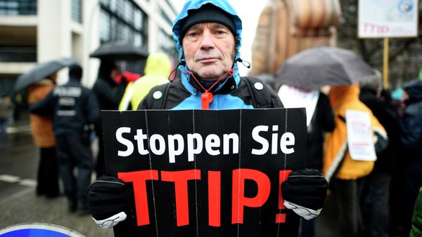 A protester holds up a sign, reading: Stop TTIP! (Transatlantic Trade and Investment Partnership) A protester holds up a sign, reading: Stop TTIP! (Transatlantic Trade and Investment Partnership) - Sputnik International