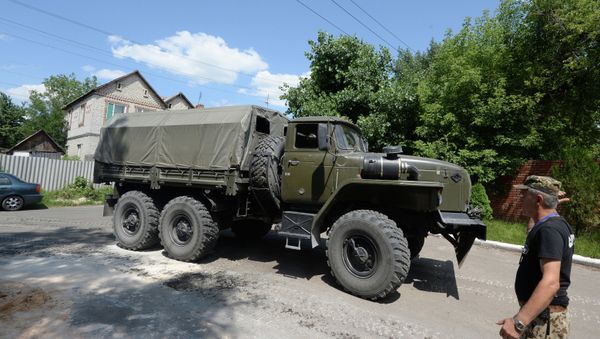 A military truck ran over the car of a local resident in Severodonetsk, Ukraine. The soldier driving the military vehicle was intoxicated. - Sputnik International