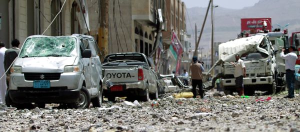 Yemeni men check a damaged street following a raid by Saudi-led coalition warplanes on a nearby missile depot on Fajj Attan hill, in the rebel-held part of the Yemeni capital, in southern Sanaa, on April 20, 2015 Yemeni men check a damaged street following a raid by Saudi-led coalition warplanes on a nearby missile depot on Fajj Attan hill, in the rebel-held part of the Yemeni capital, in southern Sanaa, on April 20, 2015 - Sputnik International