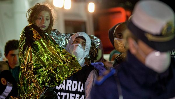 A migrant is helped disembark in the Sicilian harbor of Pozzallo, Italy, early Monday, April 20, 2015 A migrant is helped disembark in the Sicilian harbor of Pozzallo, Italy, early Monday, April 20, 2015 - Sputnik International