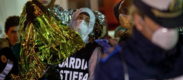A migrant is helped disembark in the Sicilian harbor of Pozzallo, Italy, early Monday, April 20, 2015 A migrant is helped disembark in the Sicilian harbor of Pozzallo, Italy, early Monday, April 20, 2015 - Sputnik International