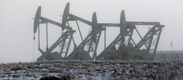 In this Dec. 19, 2014 file photo, oil pump jacks work in unison on a foggy morning in Williston, N.D. The North Dakota Legislature is looking at restructuring oil taxes as a hedge against falling crude prices - Sputnik International