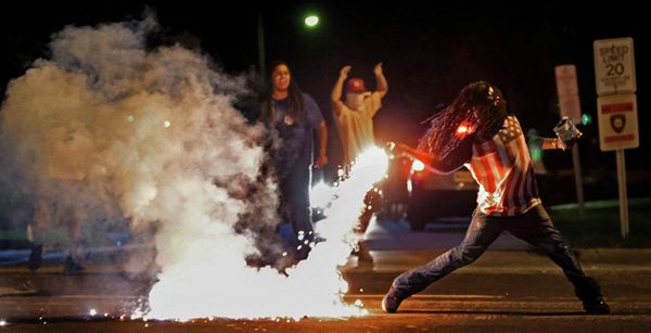 This August 13, 2014, photo by St. Louis Post Dispatch photographer Robert Cohen shows Edward Crawford returning a tear gas canister fired by police who were trying to disperse protesters in Ferguson, Missouri This August 13, 2014, photo by St. Louis Post Dispatch photographer Robert Cohen shows Edward Crawford returning a tear gas canister fired by police who were trying to disperse protesters in Ferguson, Missouri - Sputnik International