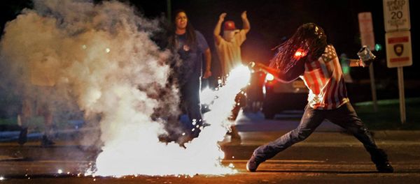This August 13, 2014, photo by St. Louis Post Dispatch photographer Robert Cohen shows Edward Crawford returning a tear gas canister fired by police who were trying to disperse protesters in Ferguson, Missouri This August 13, 2014, photo by St. Louis Post Dispatch photographer Robert Cohen shows Edward Crawford returning a tear gas canister fired by police who were trying to disperse protesters in Ferguson, Missouri - Sputnik International