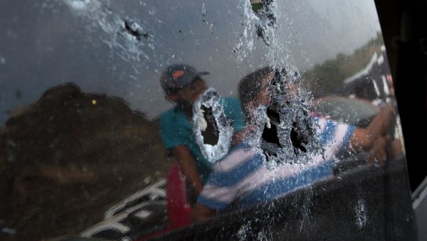 Bullet hole-riddled back windshield of a pickup truck involved in the shooting in Apatzingan, Michoacan state, Mexico. - Sputnik International