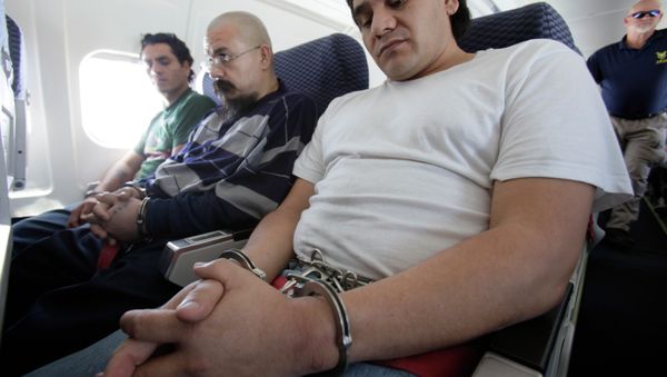 Shackled Mexican immigrants sit aboard a deportation jet charted by the US Immigration and Customs Enforcement. - Sputnik International