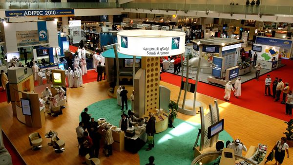 Visitors pass by the stand of Saudi Arabia's national oil company Aramco at the Abu Dhabi International Petroleum Exhibition and Conference (ADIPEC) in Abu Dhabi on November 3, 2008 - Sputnik International
