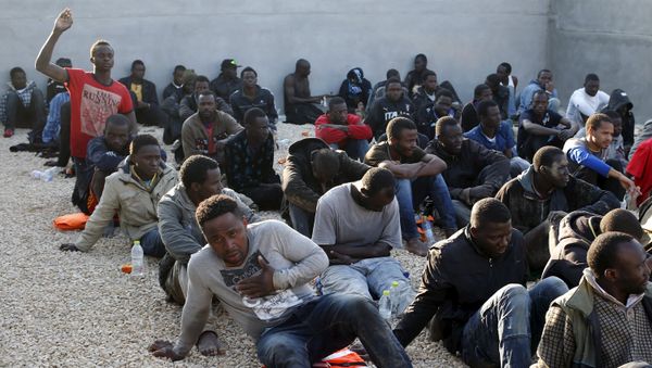 Illegal migrants sit in a coastal police base in Tripoli March 13, 2015 Illegal migrants sit in a coastal police base in Tripoli March 13, 2015 - Sputnik International