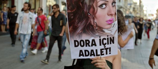 People march with a photograph of Dora Oezer, a transsexual Turkish woman, who according to local media was killed in Kusadasi, to protest violence against members of the gay and transsexual community members, in Istanbul, Turkey, Friday, July 12, 2013. File Photo - Sputnik International