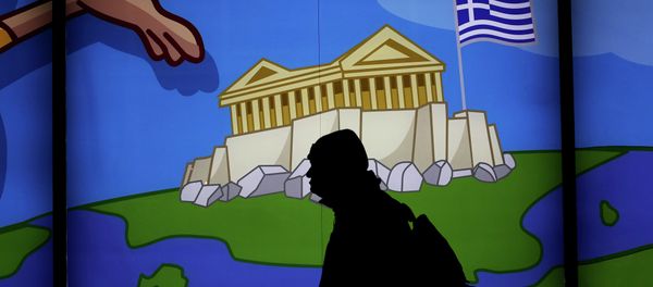 A man walks past a shop with a display window featuring the Acropolis in Athens , on March 14, 2105 - Sputnik International