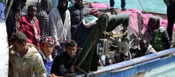 Migrants arrive at the port in the Tunisian town of Zarzis, some 50 kilometres west of the Libyan border, following their rescue by Tunisia's coastguard and navy after their vessel overturned off Libya, on April 13, 2015 Migrants arrive at the port in the Tunisian town of Zarzis, some 50 kilometres west of the Libyan border, following their rescue by Tunisia's coastguard and navy after their vessel overturned off Libya, on April 13, 2015 - Sputnik International