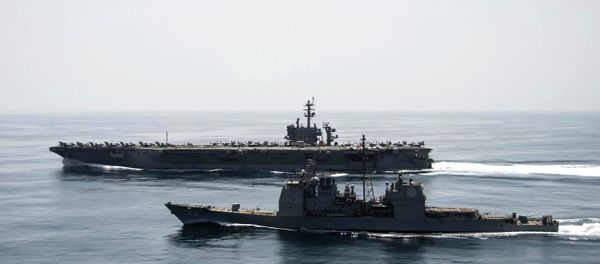 The aircraft carrier USS Theodore Roosevelt (CVN 71) and the guided-missile cruiser USS Normandy (CG 60) operate in the Arabian Sea conducting maritime security operations in this U.S. Navy photo taken April 21, 2015 - Sputnik International