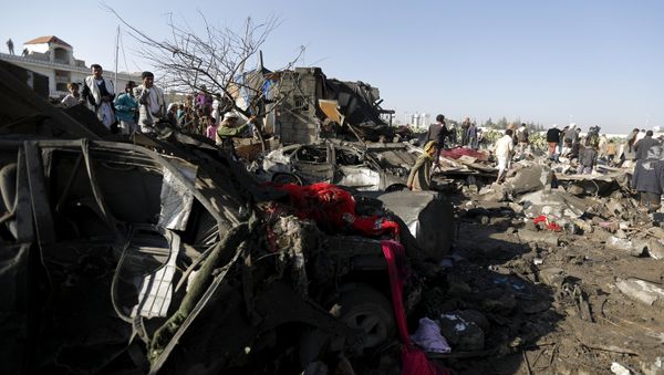People gather at the site of an air strike at a residential area near Sanaa Airport - Sputnik International