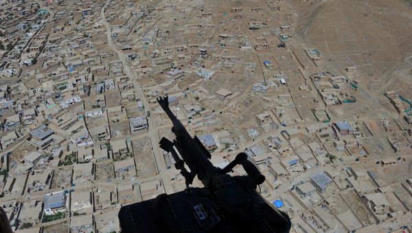 Residential houses and a mounted machine gun manned by an Afghan National Army soldier is pictured during a helicopter flight - Sputnik International