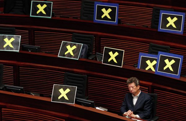 Pro-democracy lawmaker Ronny Tong sits with placards of yellow crosses placed Pro-democracy lawmaker Ronny Tong sits with placards of yellow crosses placed - Sputnik International