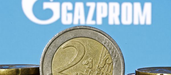 Euro coins are seen in front of displayed logo of Gazprom - Sputnik International