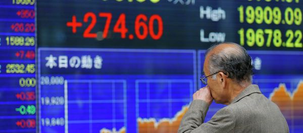 A man looks at an electronic stock indicator of a securities firm in Tokyo - Sputnik International