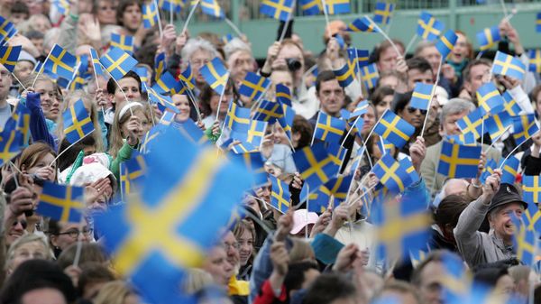 Swedes wave with flags in the Skansen open-air museum in Stockholm 06 June 2005 when the National Day for the first time is celebrated as a national holiday in Sweden Swedes wave with flags in the Skansen open-air museum in Stockholm 06 June 2005 when the National Day for the first time is celebrated as a national holiday in Sweden - Sputnik International