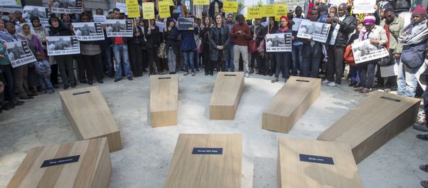 Members of NGOs and asylum seekers take part in rally called Funeral march outside the European Council headquarters where EU leaders seek for a solution to the migrants crisis during an extraordinary summit in Brussels April 23, 2015 Members of NGOs and asylum seekers take part in rally called Funeral march outside the European Council headquarters where EU leaders seek for a solution to the migrants crisis during an extraordinary summit in Brussels April 23, 2015 - Sputnik International