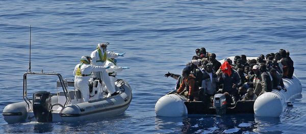 Migrants crowd and inflatable dinghy as rescue vassel  Denaro  (not in picture) of the Italian Coast Guard approaches them, off the Libyan coast, in the Mediterranean Sea - Sputnik International