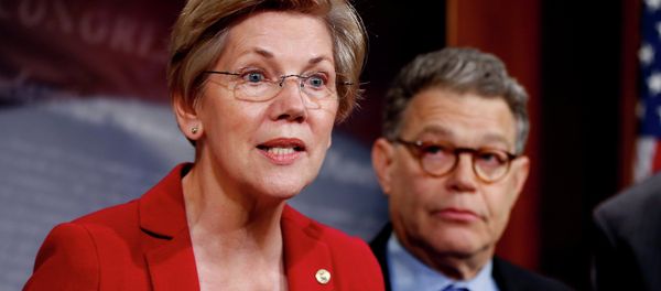 Sen. Elizabeth Warren, D-Mass, left, speaks at a new conference on Capitol Hill in Washington. - Sputnik International