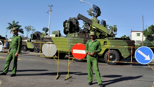 Cuban soldiers guard military vehicles, during a parade rehearsal at Revolution Square in Havana - Sputnik International