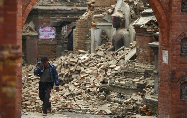A man cries as he walks on the street while passing through a damaged statue of Lord Buddha a day after an earthquake in Bhaktapur, Nepal A man cries as he walks on the street while passing through a damaged statue of Lord Buddha a day after an earthquake in Bhaktapur, Nepal - Sputnik International