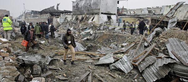 An Afghan investigation team stand in rubble caused by a car bomb explosion in Kabul, Afghanistan. An Afghan investigation team stand in rubble caused by a car bomb explosion in Kabul, Afghanistan. - Sputnik International