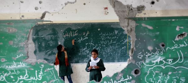 Palestinian girls play inside their school which was destroyed during the 50 days of conflict between Israel and Hamas last summer, in the Shejaiya neighborhood of Gaza City, on November 5, 2014 Palestinian girls play inside their school which was destroyed during the 50 days of conflict between Israel and Hamas last summer, in the Shejaiya neighborhood of Gaza City, on November 5, 2014 - Sputnik International
