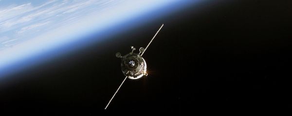 In this 11 June, 2003 NASA image an unmanned Progress supply vehicle (L), backdropped by the blackness of space and Earth's horizon, approaches the Pirs Docking Compartment (out of frame) attached to the Zvezda Service Module on the International Space Station (ISS) - Sputnik International