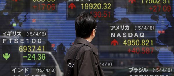 A pedestrian looks at an electronic board showing the stock market indices of various countries outside a brokerage in Tokyo April 9, 2015 A pedestrian looks at an electronic board showing the stock market indices of various countries outside a brokerage in Tokyo April 9, 2015 - Sputnik International
