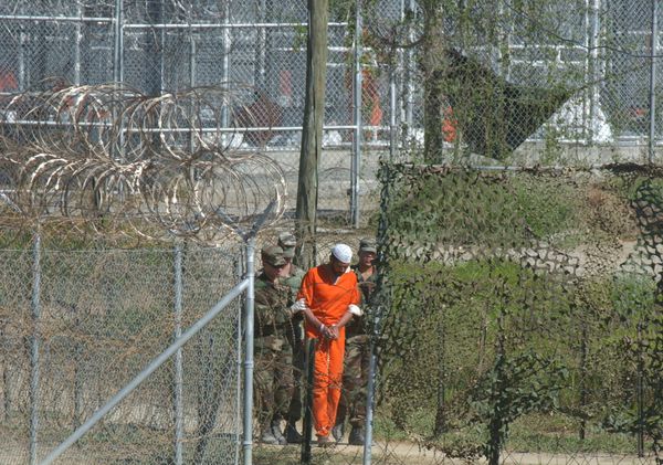 A detainee is escorted to interrogation by U.S. military guards at Camp X-Ray at Guantanamo Bay. A detainee is escorted to interrogation by U.S. military guards at Camp X-Ray at Guantanamo Bay. - Sputnik International