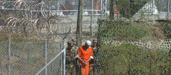 A detainee is escorted to interrogation by U.S. military guards at Camp X-Ray at Guantanamo Bay. A detainee is escorted to interrogation by U.S. military guards at Camp X-Ray at Guantanamo Bay. - Sputnik International