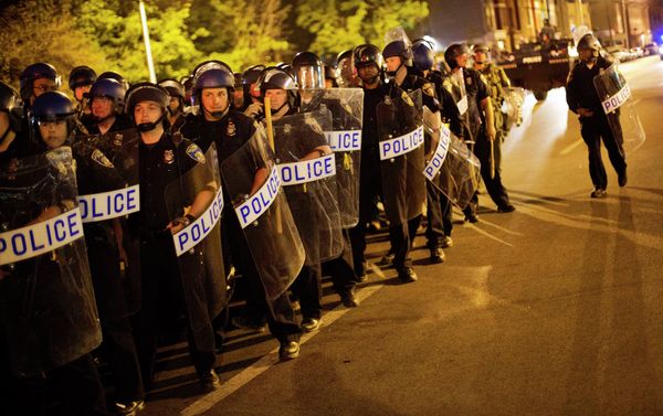 Police in riot gear line up near the scene of Monday's riots ahead of a 10 p.m. curfew Wednesday, April 29, 2015, in Baltimore. The curfew was imposed after unrest in Baltimore over the death of Freddie Gray while in police custody. Police in riot gear line up near the scene of Monday's riots ahead of a 10 p.m. curfew Wednesday, April 29, 2015, in Baltimore. The curfew was imposed after unrest in Baltimore over the death of Freddie Gray while in police custody. - Sputnik International